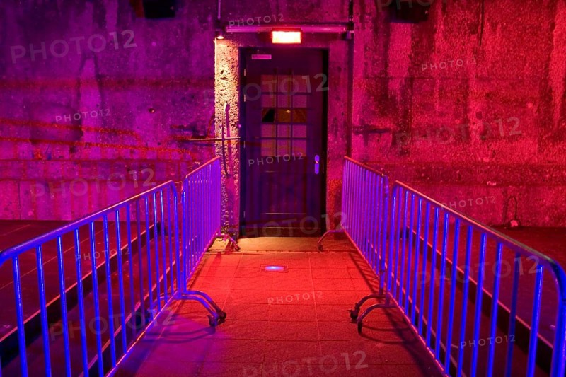 Entrance door of Disco, nightclub, discotheque P1 which means Prinzregentenstrasse 1, illuminated in red, lilac, violet light, Munich, Bavaria, Germany, Europe