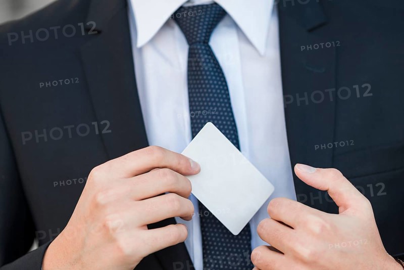 Elegant businessman showing business card
