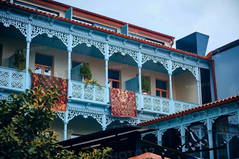 Colorful carpets hanging on balconies of restored traditional house in Old Town of Tbilisi, Georgia, Asia