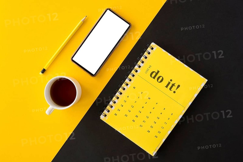 Top view planner yellow calendar coffee