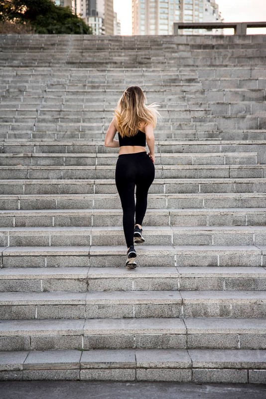 Young woman running outdoors with sportswear