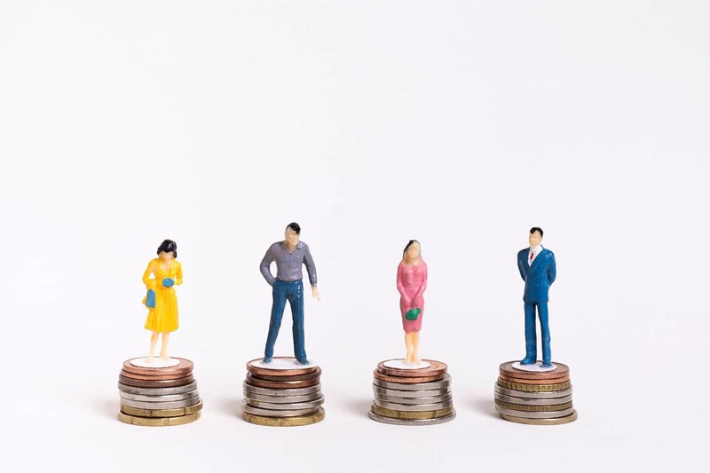 Business man woman sitting equal piles coins