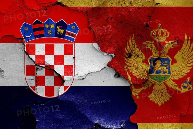 Flags of Croatia and Montenegro painted on cracked wall