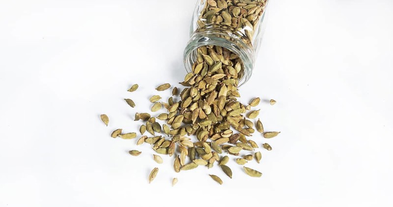 Cardamom (elettaria Cardamomum), spice falling against White Background