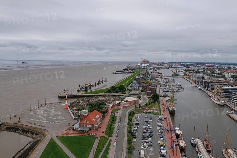 Panoramic view of a harbour town with a long dyke, streets and individual buildings along the water, Bremerhaven, Bremen, Germany, Europe