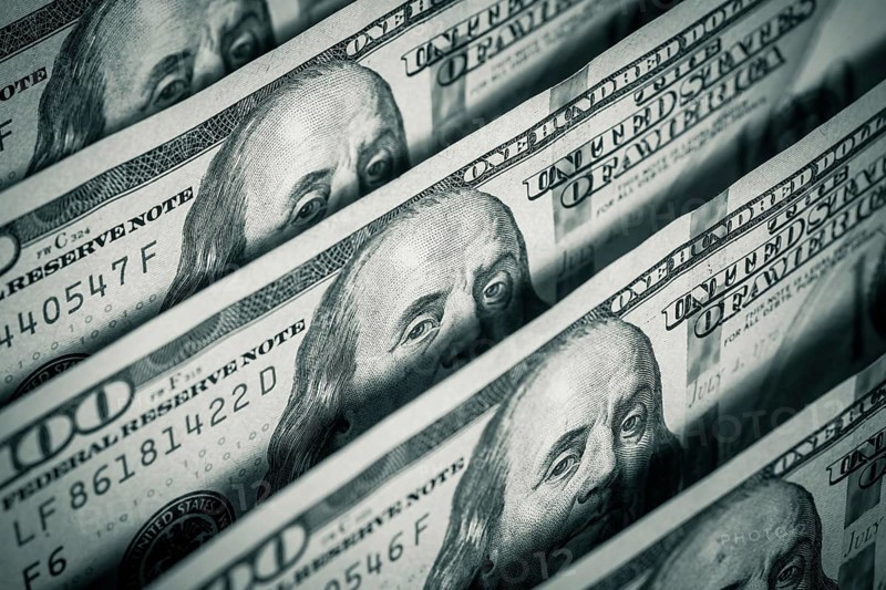 Hundred dollars bills standing in a row. Selective focus