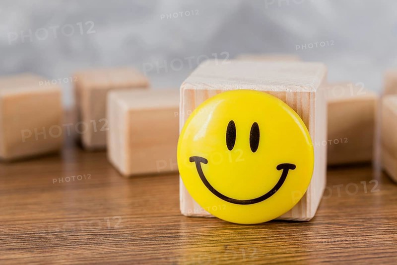 Front view smiley face wooden block. High resolution photo