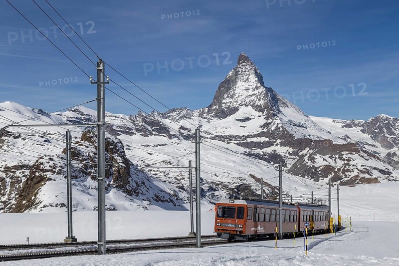 Zermatt, Switzerland, April 12, 2017: The red Gornergrat Train in front of the snowy Matterhorn mountain, Europe