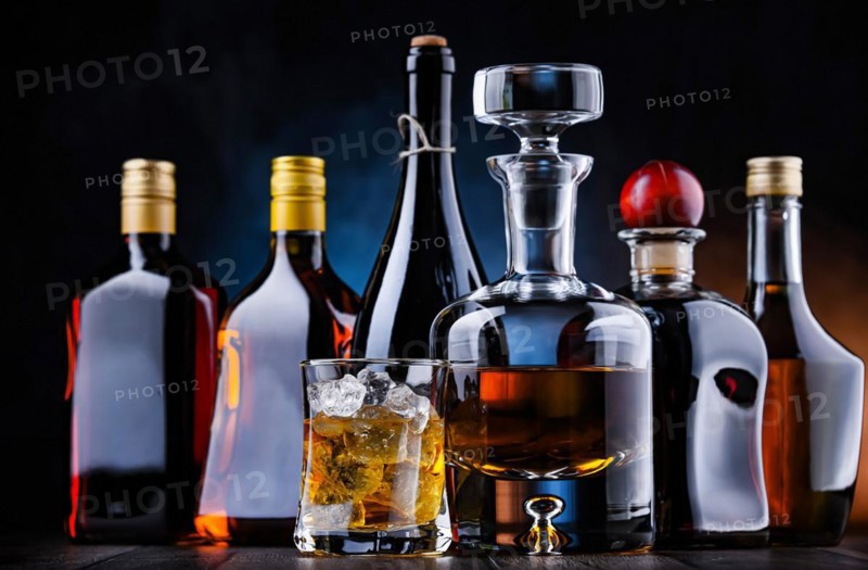 Composition with bottles of assorted alcoholic beverages