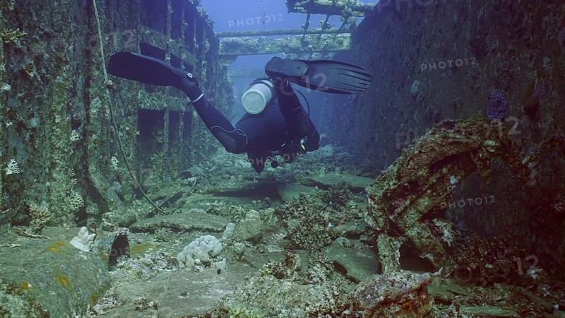 Scuba diver swim down corridor of ferry Salem Express shipwreck, Red sea, Safaga, Egypt, Africa
