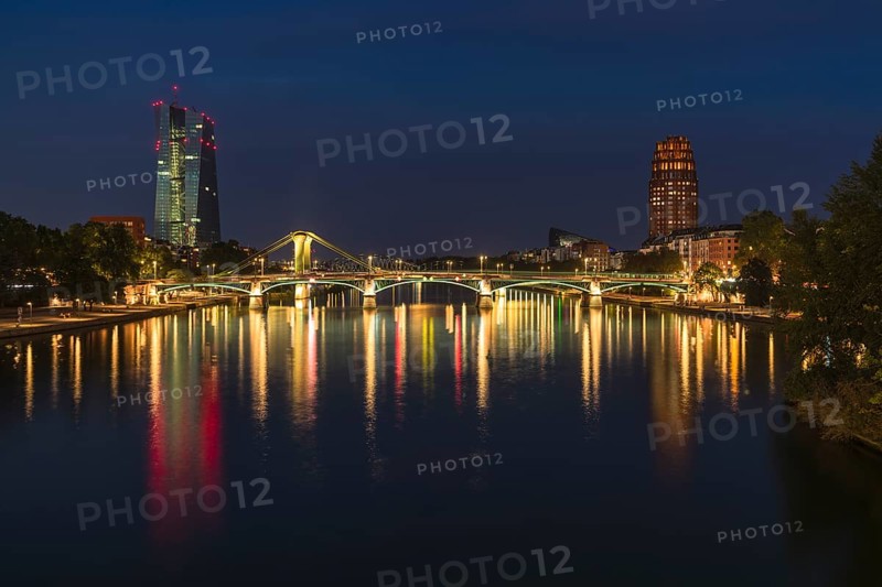 View at blue hour of the colourfully illuminated Flößerbrücke, the European Central Bank on the left and the Main Plaza on the right, Alte Brücke, Frankfurt am Main, Hesse, Germany, Europe