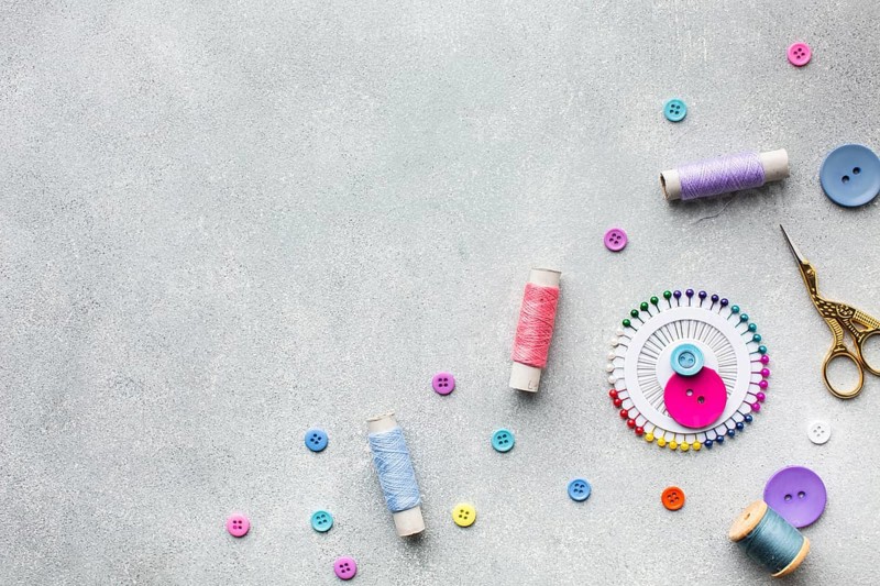 Arrangement colourful sewing threads buttons