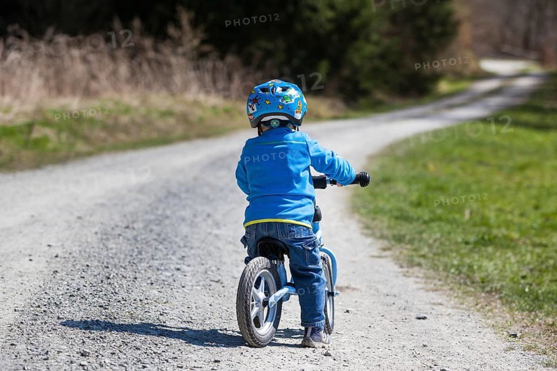 Child with a running bike