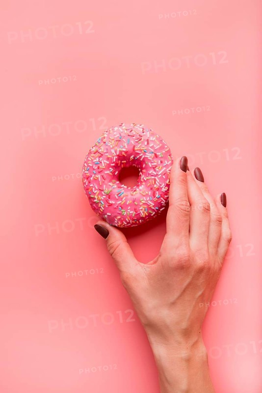 Top view hand holding donut