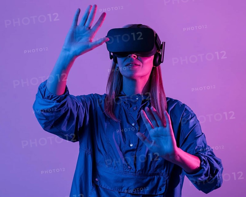 Woman wearing vr glasses with purple light