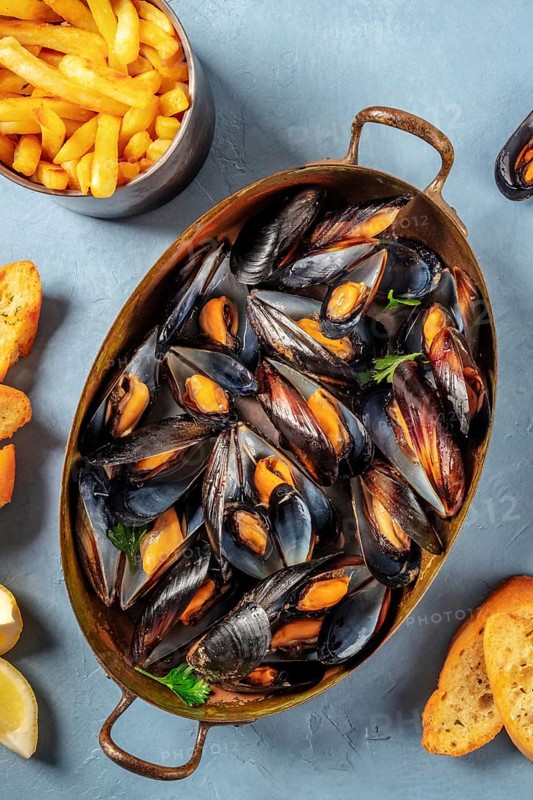 Moules frites, Belgian mussels with French fries, shot from above