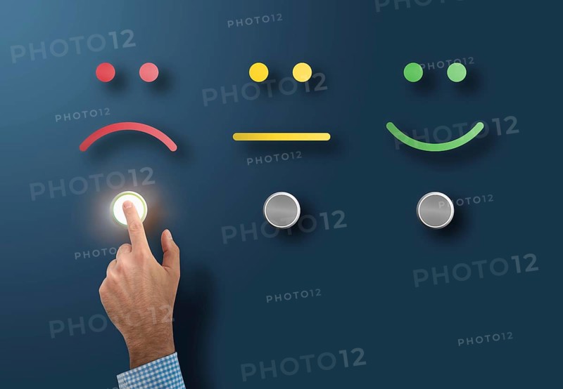customer service rating and survey concept with dissatisfied customer touching interface button with sad face