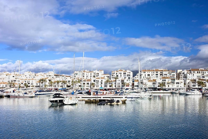 Marina waterfront with luxury motor yachts in holiday resort town of Puerto Banus on Costa del Sol, near Marbella in Spain, Malaga province