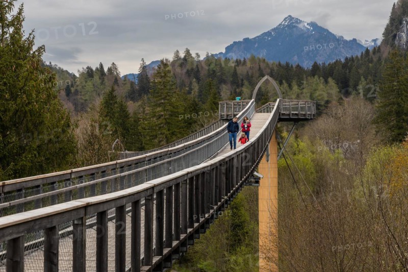 A family is enjoying the views from a treetop walk in Ziegelwies, a town near the border between Austria and Germany with views over the Tyrol mountains