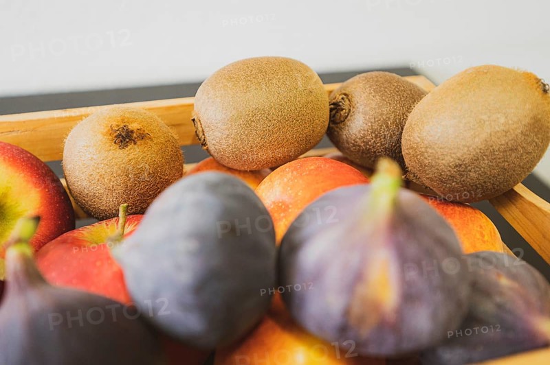 Apples, kiwi and fig in a wooden fruit basket as a healthy meal, Hanover, Lower Saxony, Germany, Europe