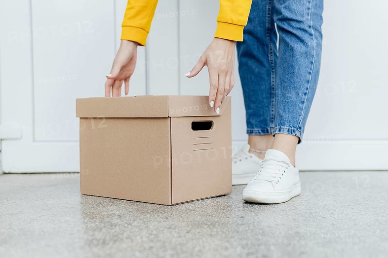 Close up hands lifting box
