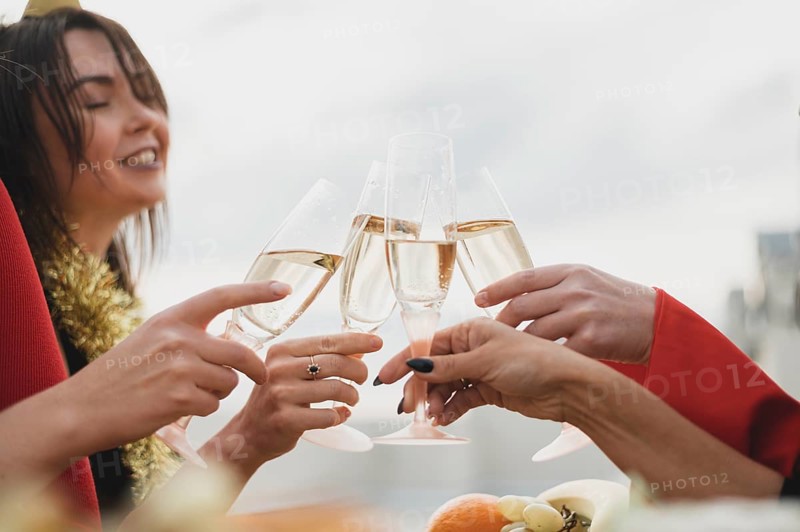Happy girls cheering up glasses champagne