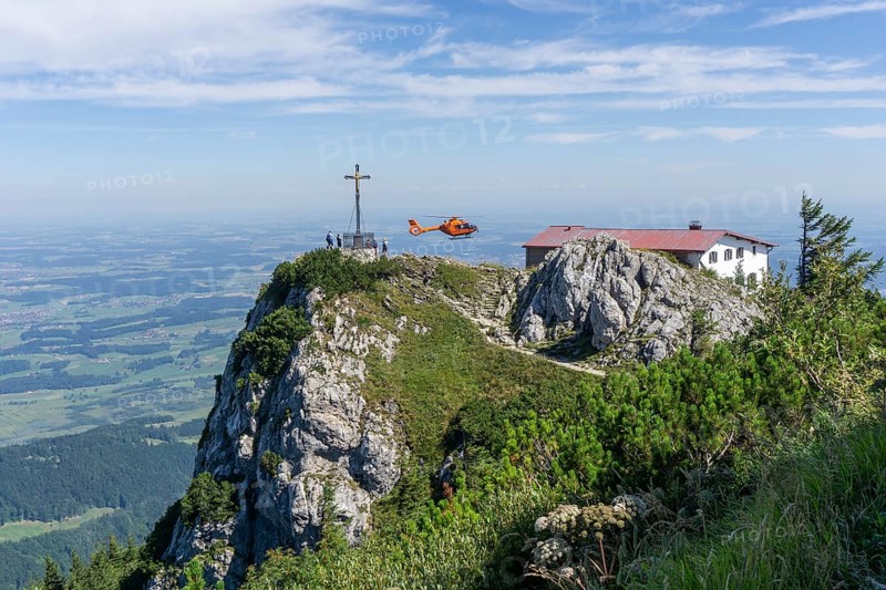 Air rescue helicopter flies to Hochfelln mountain, Bergen, Chiemgau, Upper Bavaria, Germany, Europe