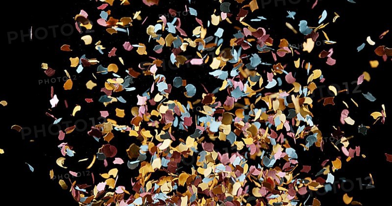Confettis Falling against Black Background