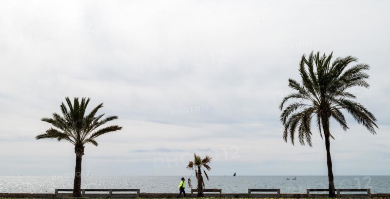 View of the sea and pedestrians from the seafront road Ma-19, Avenida de Gabrial Roca, Autopista de Llevant, directly in front of la Seu Cathedral, Palma de Majorca, Majorca, Balearic Islands, Spain, Europe