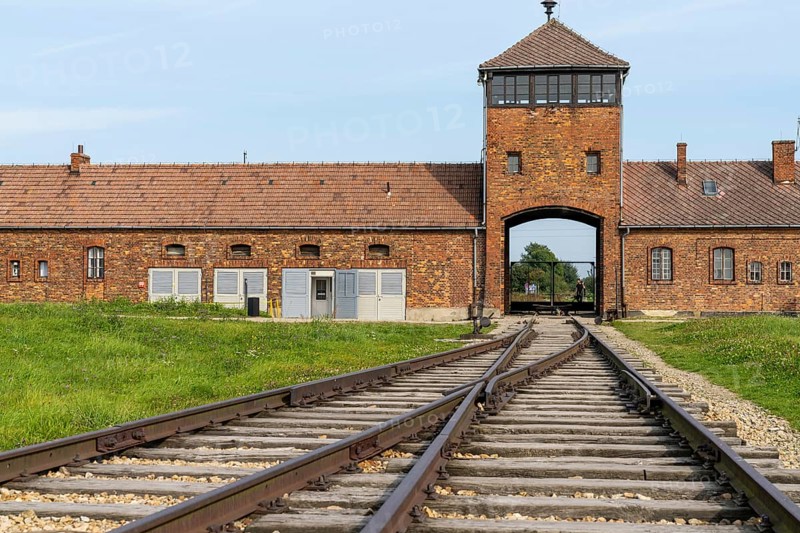 Auschwitz, Poland - 15 September, 2021: view of the gatehouse and train tracks at Auschwitz Concentration Camp in Poland