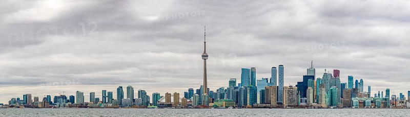 A panorama picture of the Toronto Skyline on a cloudy day taken from the islands across