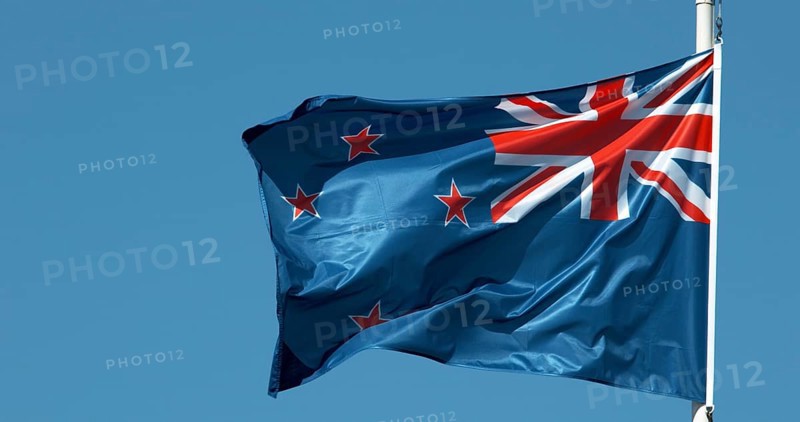 New Zealand Flag Waving in the Wind against blue sky