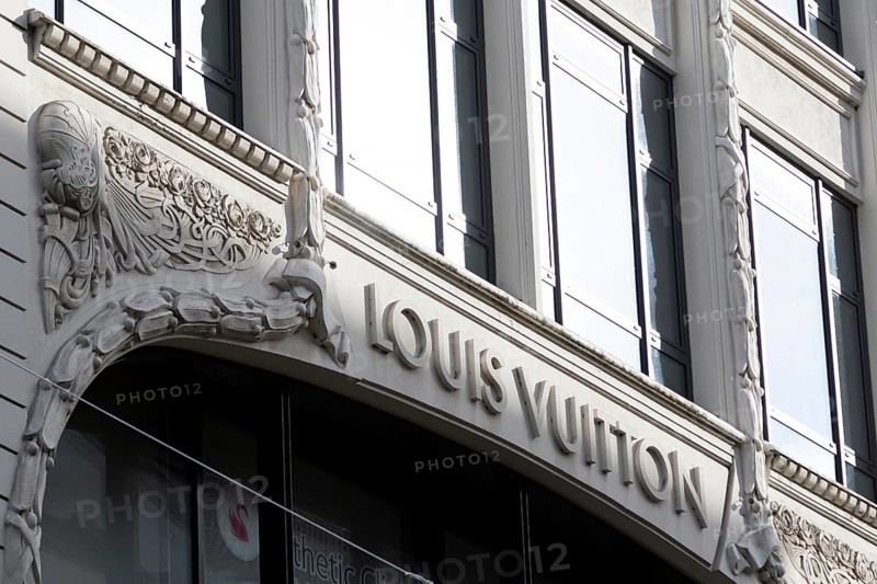 Logo of the French luxury fashion brand Louis Vuitton on the façade of a boutique in the shopping street Neuer Wall, Hamburg, Germany, Europe