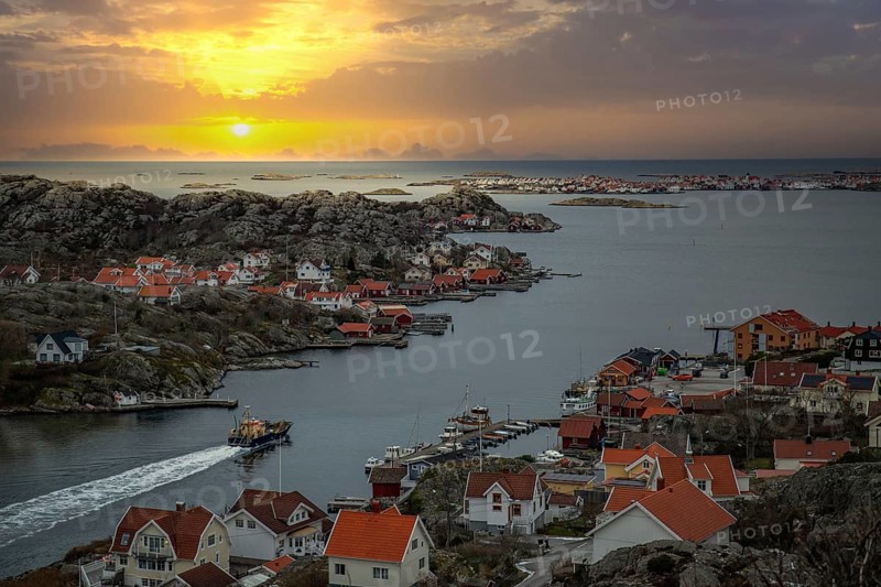 Beautiful typical Scandinavian village that winds around a coastal strip in a bay. Wintery surroundings in a fishing village. Skyline of the town of Rönnäng in Sweden