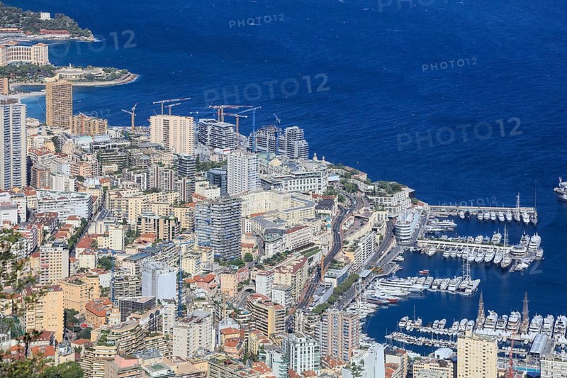 Monte-Carlo district with large construction site of the new Mareterra district built into the sea, previously called Anse du Portier, architect Renzo Piano and others with luxury properties for billionaires, on the right Port Hercule harbour, Principality of Monaco, seen from the Tete du Chien lookout mountain in La Turbie, Alpes-Maritimes department, Provence Alpes Cote d'Azur region, France, Mediterranean Sea, Europe