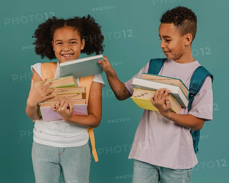 Boy helping his friend with books