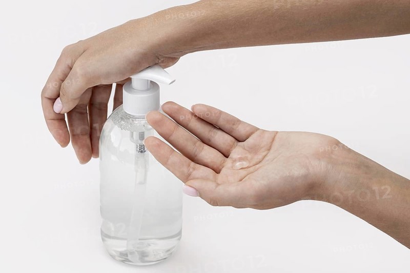 High angle person using liquid soap