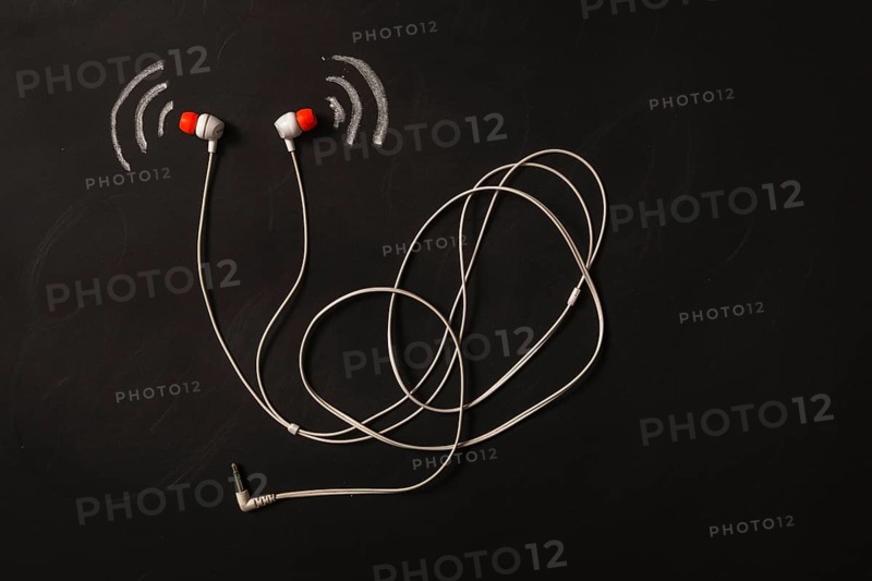 Sound wave icon near earphone blackboard. High resolution photo