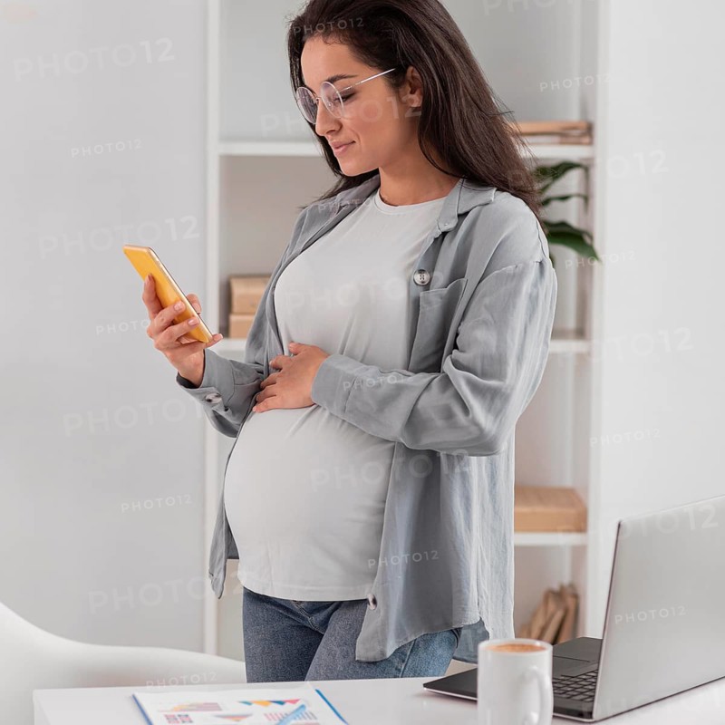 Side view pregnant woman home with laptop smartphone