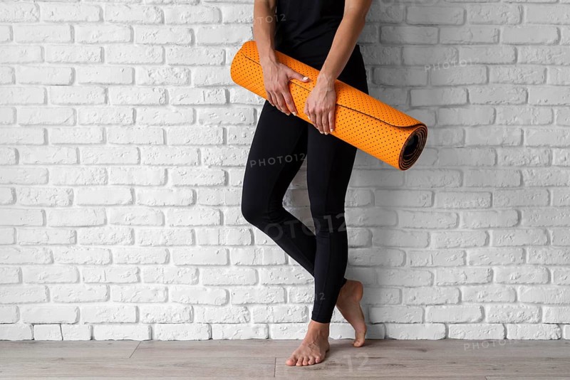 Close up hands holding yoga mat