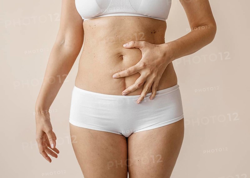 Close up hand covering belly