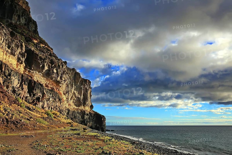 Lonely beach with cliffs on the Atlantic Ocean in the Canary Islands. Playa de Tasarte, Las Palmas, Gran Canaria, Spain, Europe