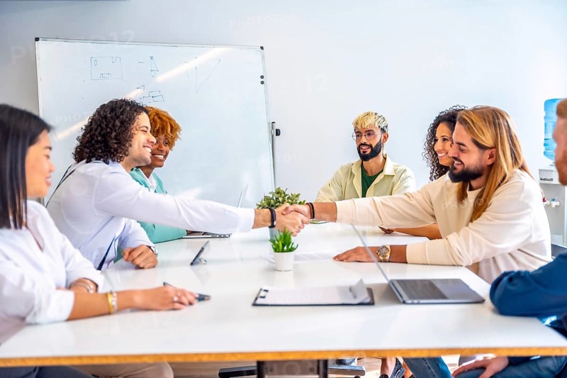 Men shaking hands during a meeting in a coworking