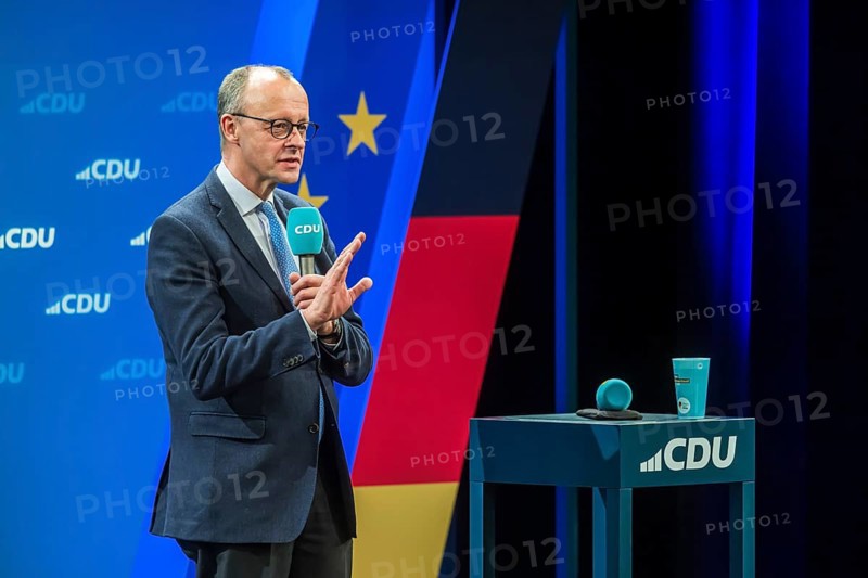Election event of the CDU party for the Bundestag elections with top candidate Friedrich Merz. Portrait in front of the German flag and the flag of the European Union. Singen am Hohentwiehl. Baden-Württemberg, Germany, Europe