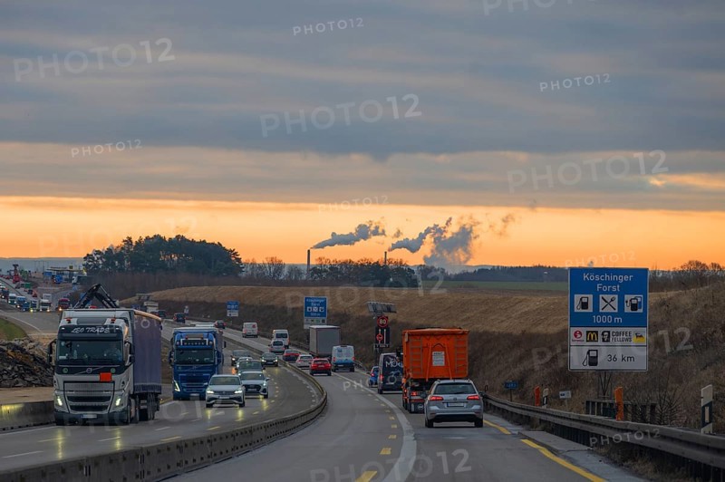 Evening traffic on the A9 motorway, smoking chimneys behind, Bavaria, Germany, Europe