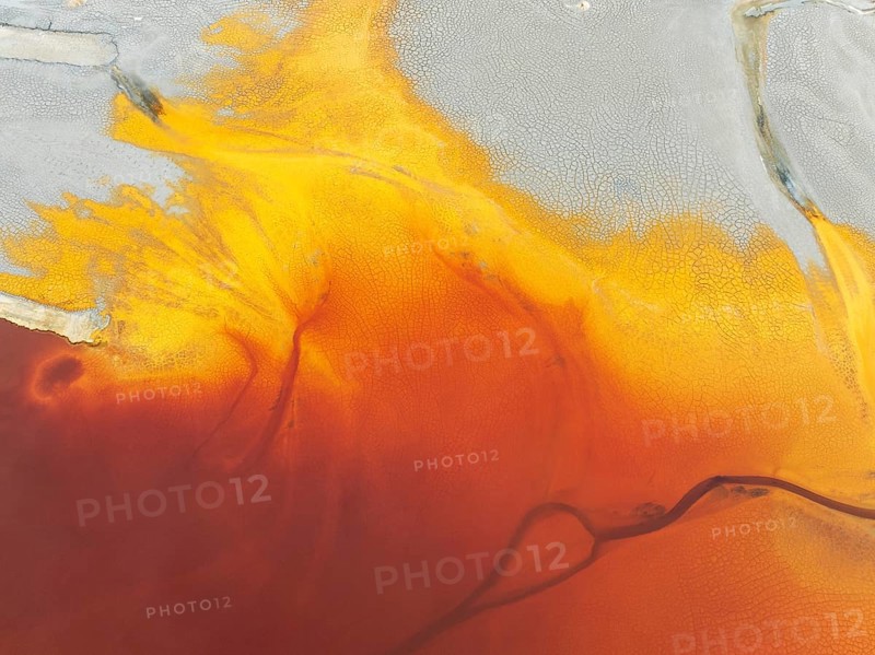 Waste pond in the mineral-rich area of the Rio Tinto mines. The colour is caused by oxidised iron minerals. Aerial view. Drone shot. Huelva province, Andalusia, Spain, Europe