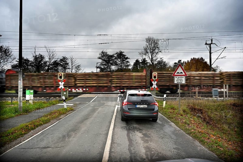 Passing goods train at a level crossing with barriers, Fürth, Middle Franconia, Bavaria, Germany, Europe