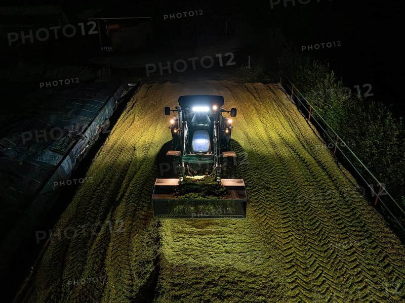 Tractor at night working on a silo filled with crop, maize harvest, Dachtel, Black Forest, Germany, Europe
