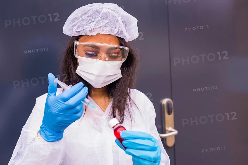 African-American doctor preparing the coronavirus vaccine, immunizes the population, people at risk, antibodies, new normal, covid-19