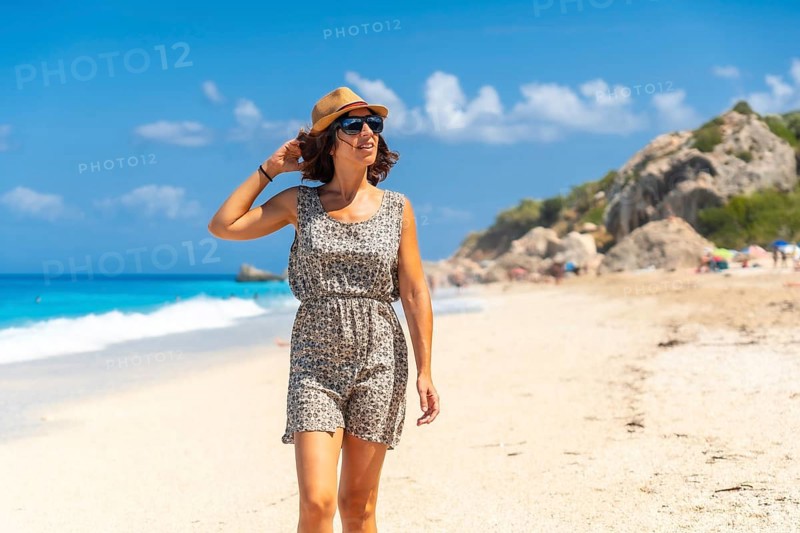 Woman enjoying summer at Megali Petra beach with turquoise water of Lefkada island, Ionian Sea, Greece, Europe